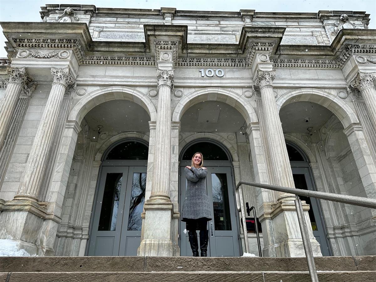Lauren in front of Pritzker Hageman as part of an International Women's Day campaign